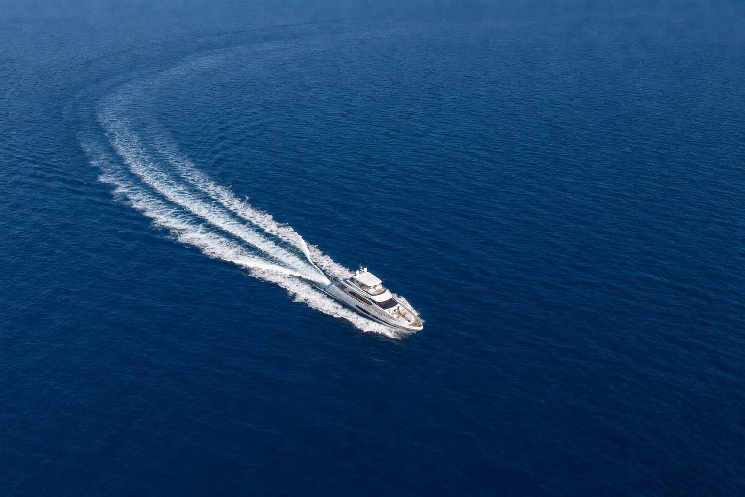 Aerial view of a yacht and its wake